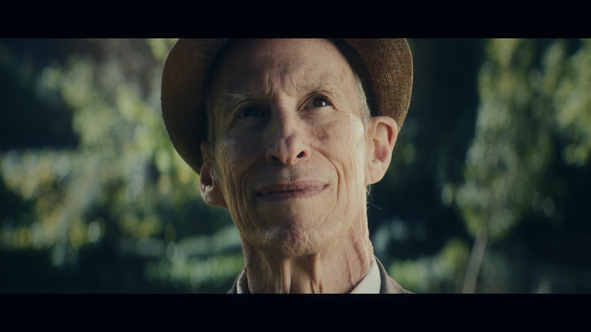 Close-up of an older man wearing a brown hat