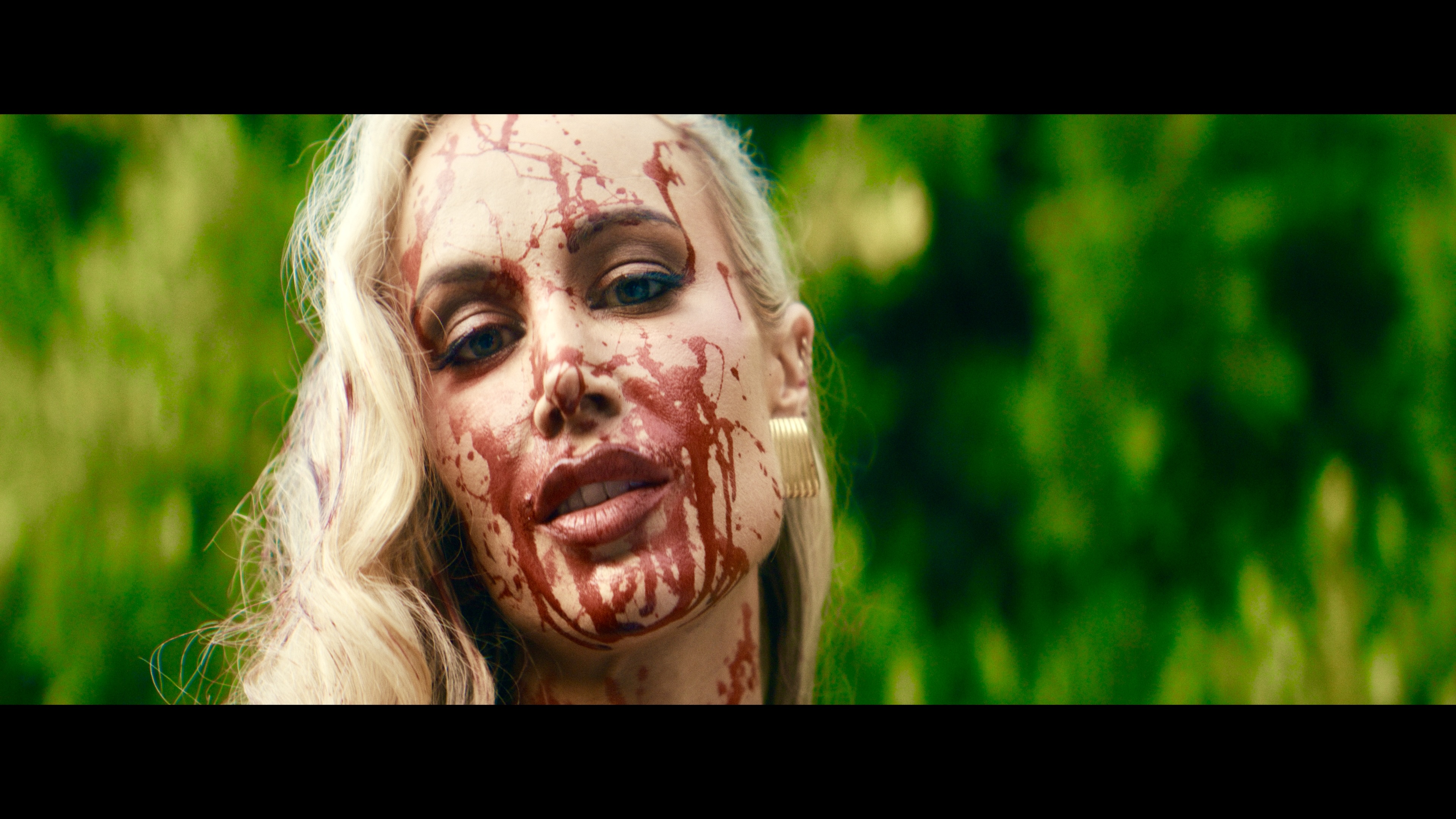 Close-up of a woman with blood on her face